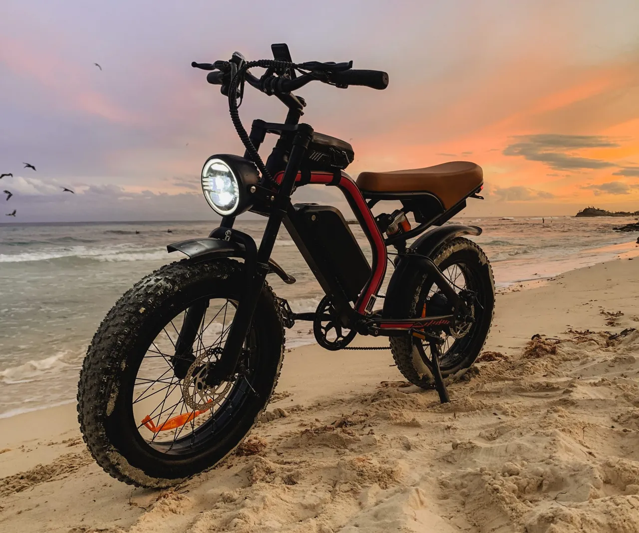 Beach Cruiser e-bike parked on a Tulum beach at sunset