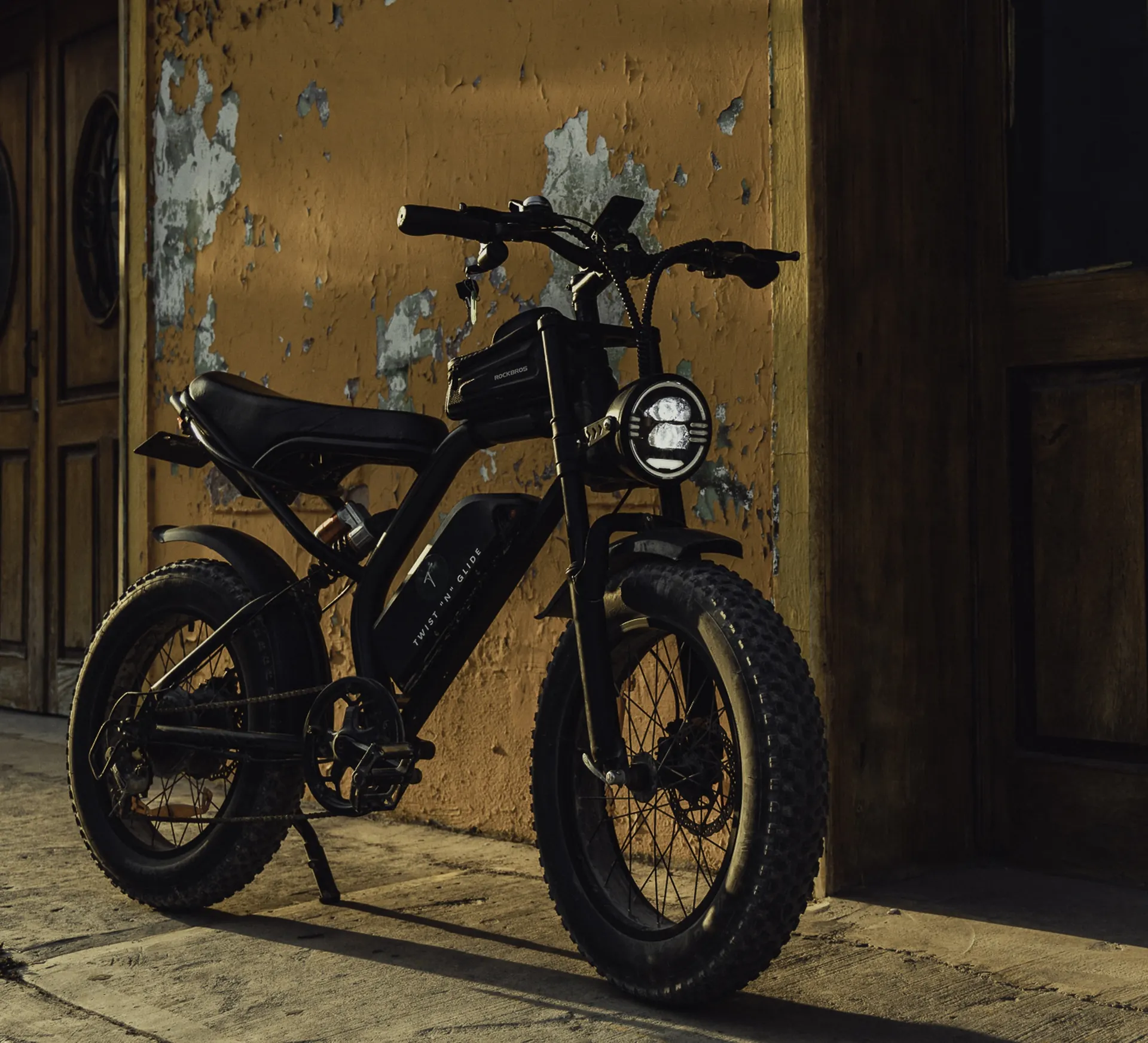 Chopper e-bike parked against a weathered Tulum wall