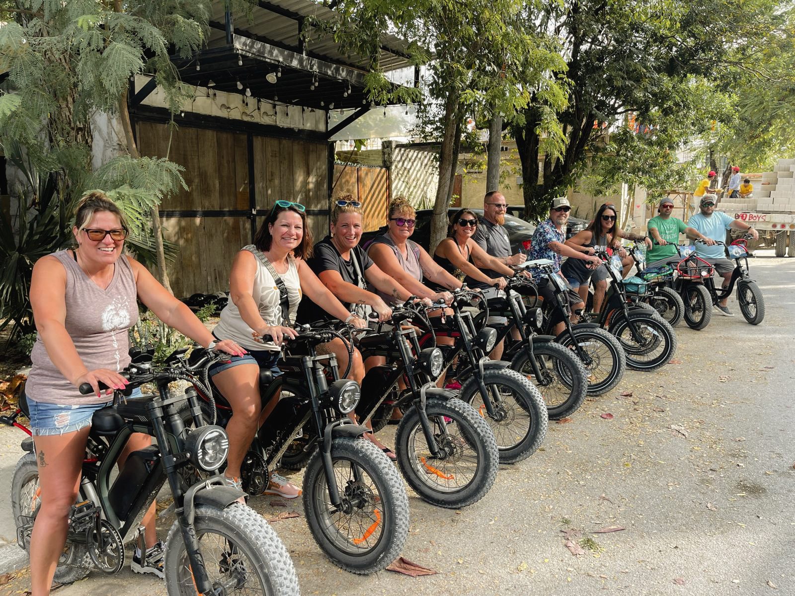 Group of friends riding e-bikes through Tulum